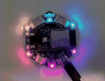 The badge LED ring running a rainbow animation across its six APA102 LEDs